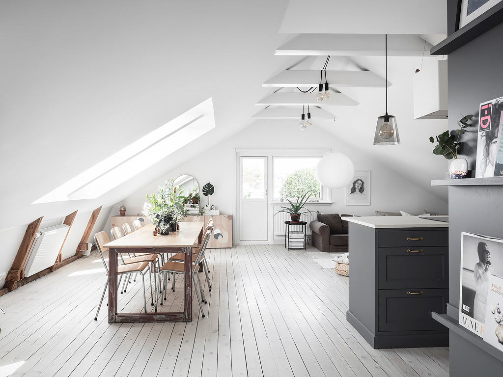 grote eettafel onder schuine wanden woonkamer dakramen